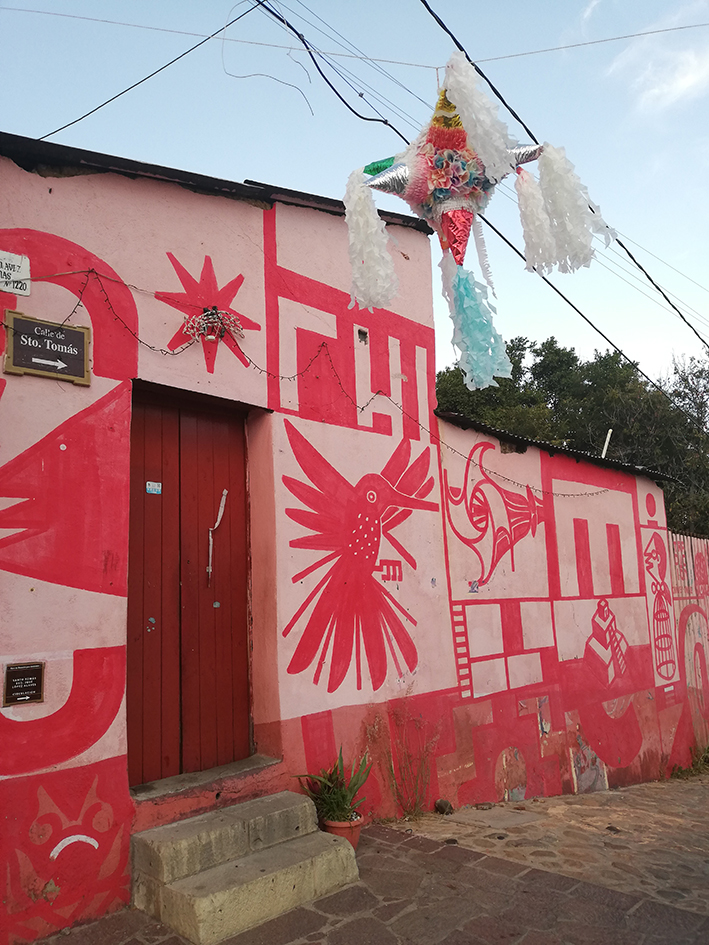 Xochimilco neighborhood in Oaxaca City with red street art of hummingbirds