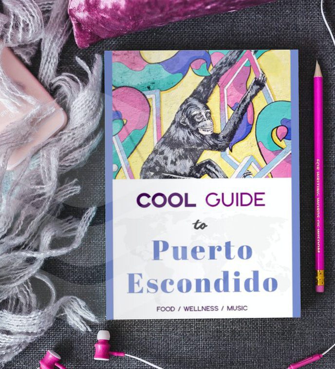 Cool Guide to Puerto Escondido travel book next to a pink iPhone with headphones, and a plate with sweets