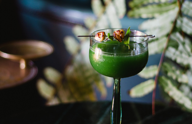 Green cocktail in a small glass at Selva restaurant in Oaxaca City