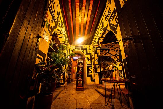Entry view of Archivo Maguey, a bar in Oaxaca City that's painted by local artist Sanez Crak.