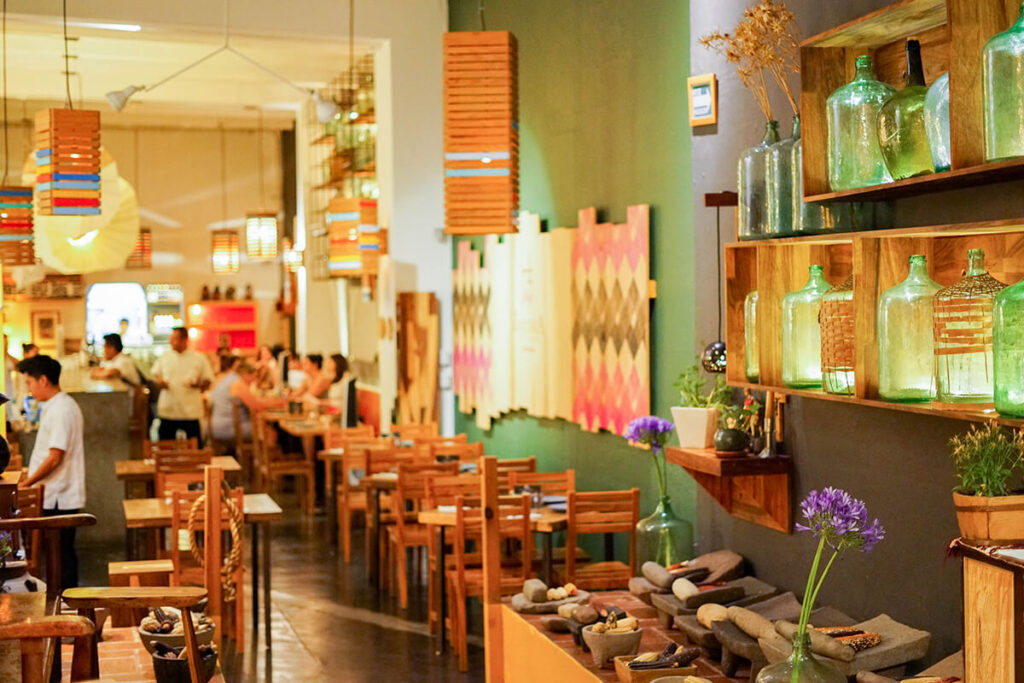 View of the entry to Zandunga restaurant and cocktail bar in Oaxaca City, tables and bar