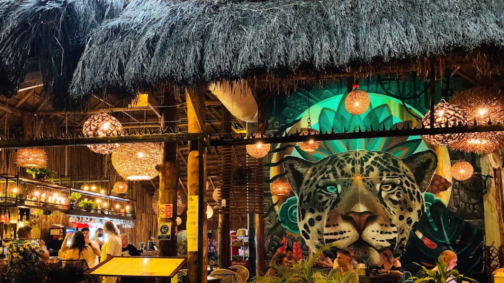 Jaguar mural in a restaurant with bamboo and wood interior