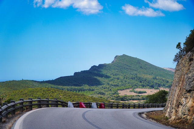 winding road towards a green mountain in portugal